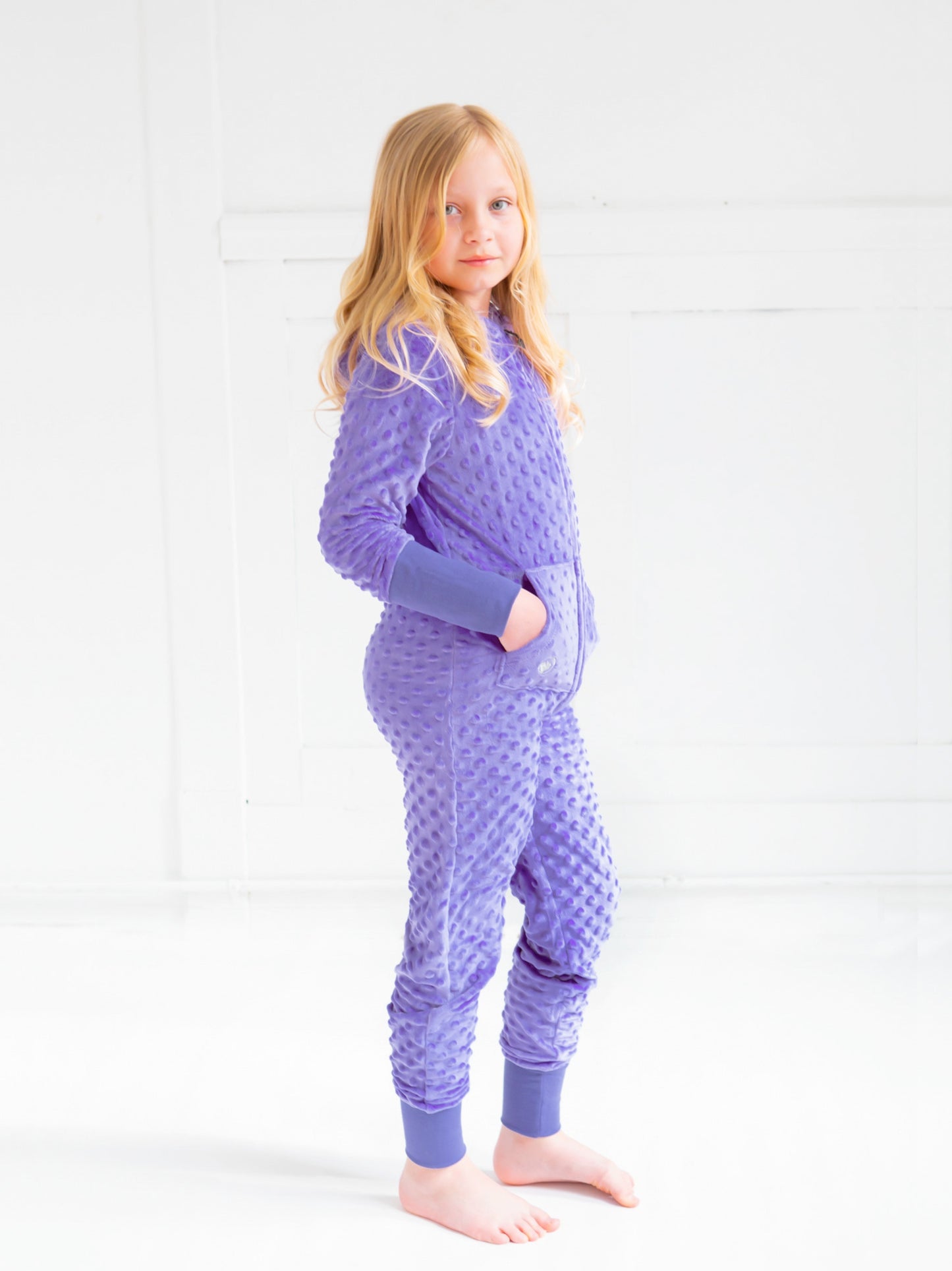 tween girl wearing minky bubble zip onesie in periwinkle